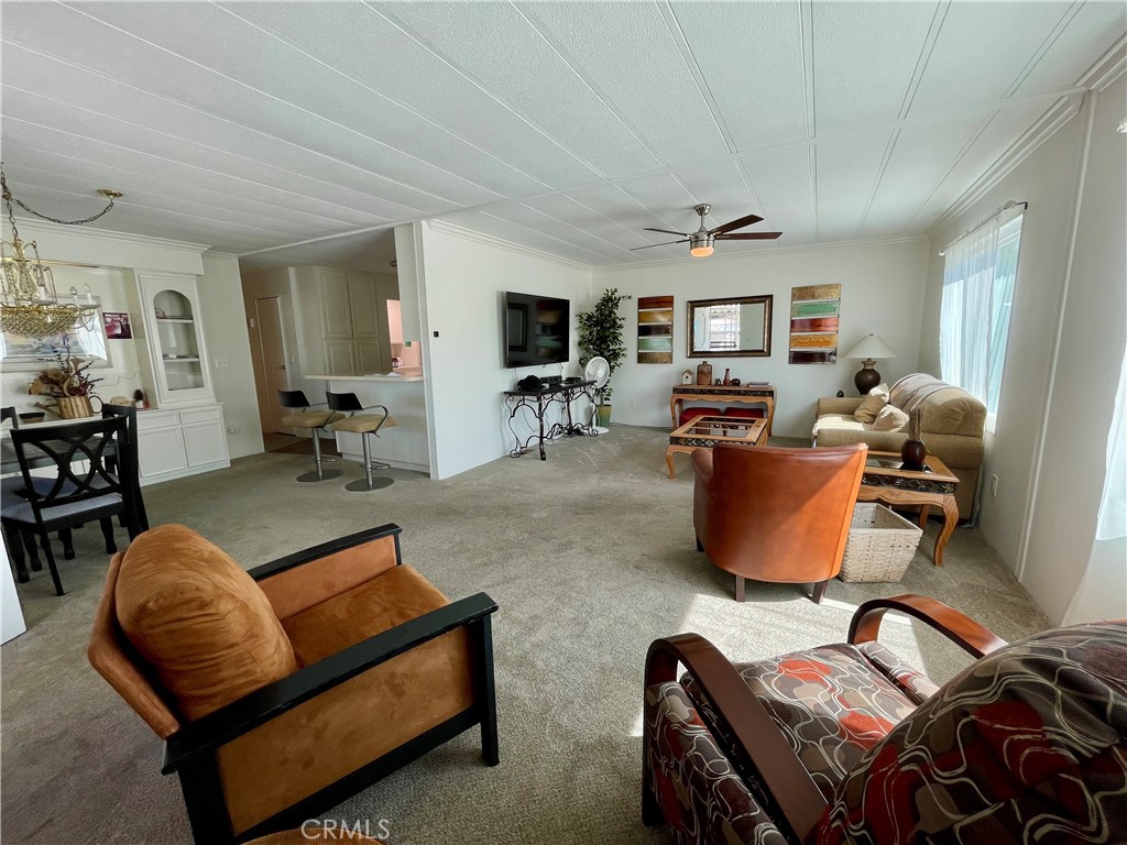 31130 South General Kearny Road, Unit 145 Temecula, CA 92591 - Photo 5 of 27 a living room with furniture ceiling fan and a window
