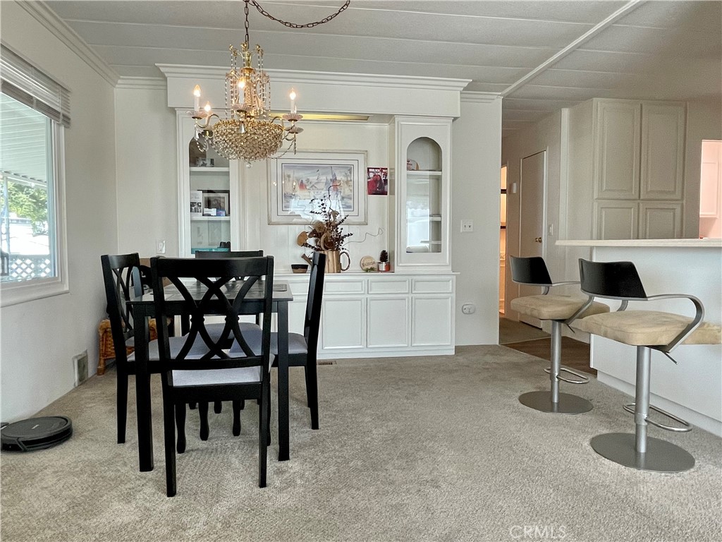 31130 South General Kearny Road, Unit 145 Temecula, CA 92591 - Photo 9 of 27 a view of a dining room with furniture and chandelier