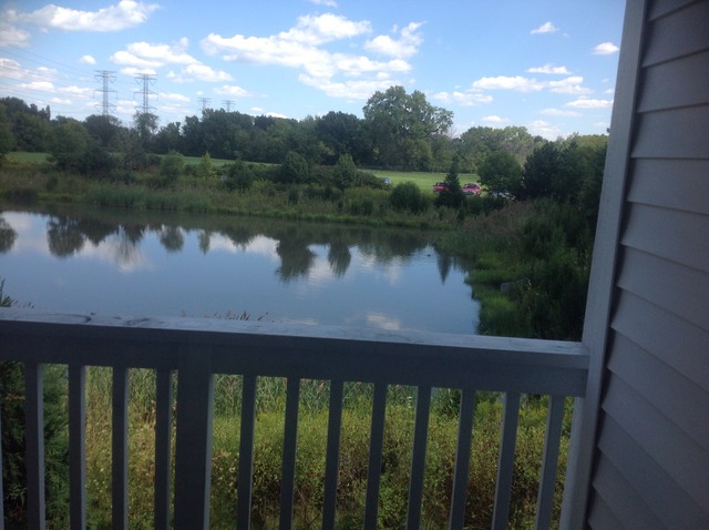 1588 McClure Road, Unit 1588 Aurora, IL 60505 - Photo 2 of 8 a view of a lake from a balcony