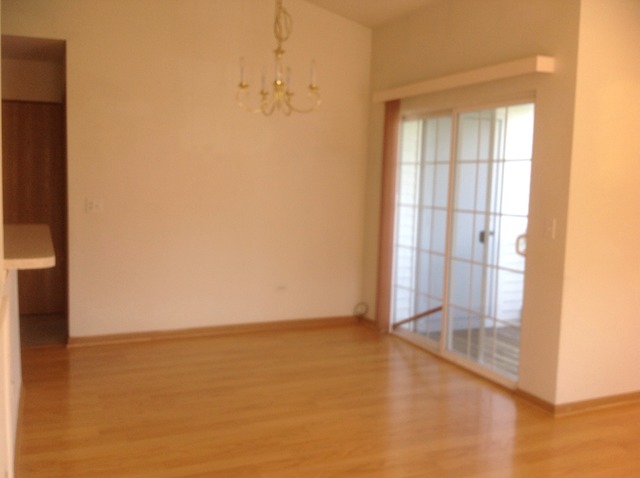 1588 McClure Road, Unit 1588 Aurora, IL 60505 - Photo 4 of 8 an empty room with windows