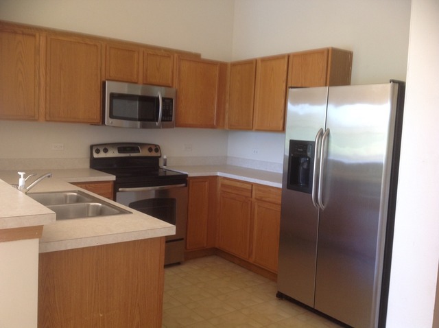 1588 McClure Road, Unit 1588 Aurora, IL 60505 - Photo 5 of 8 a kitchen with a refrigerator sink and microwave