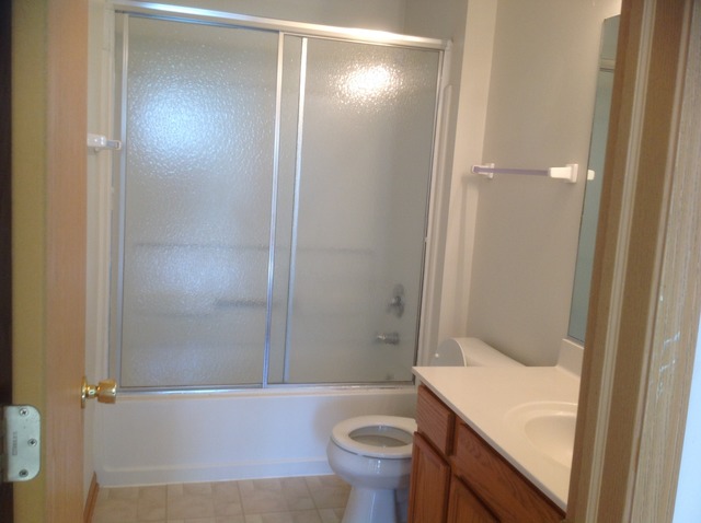 1588 McClure Road, Unit 1588 Aurora, IL 60505 - Photo 6 of 8 a bathroom with a sink a toilet and shower