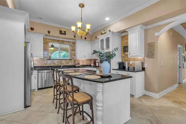 a view of a dining room and kitchen with a table chairs a workspace