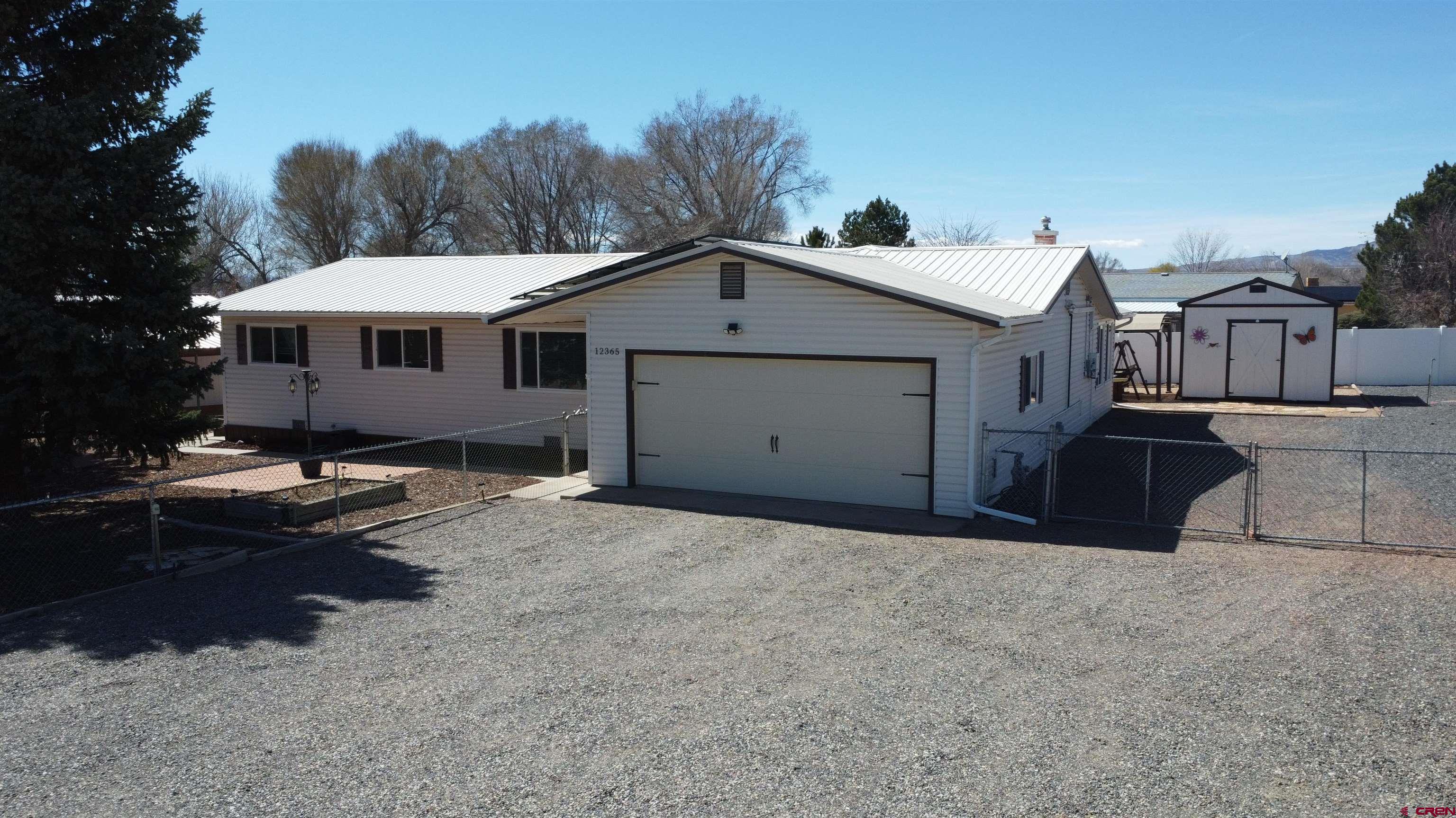 a view of a house with a patio and a yard