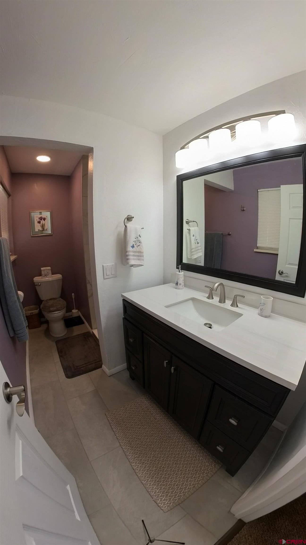 12365 East Spring Circle Eckert, CO 81418 - Photo 22 of 34 a bathroom with a double vanity sink and mirror