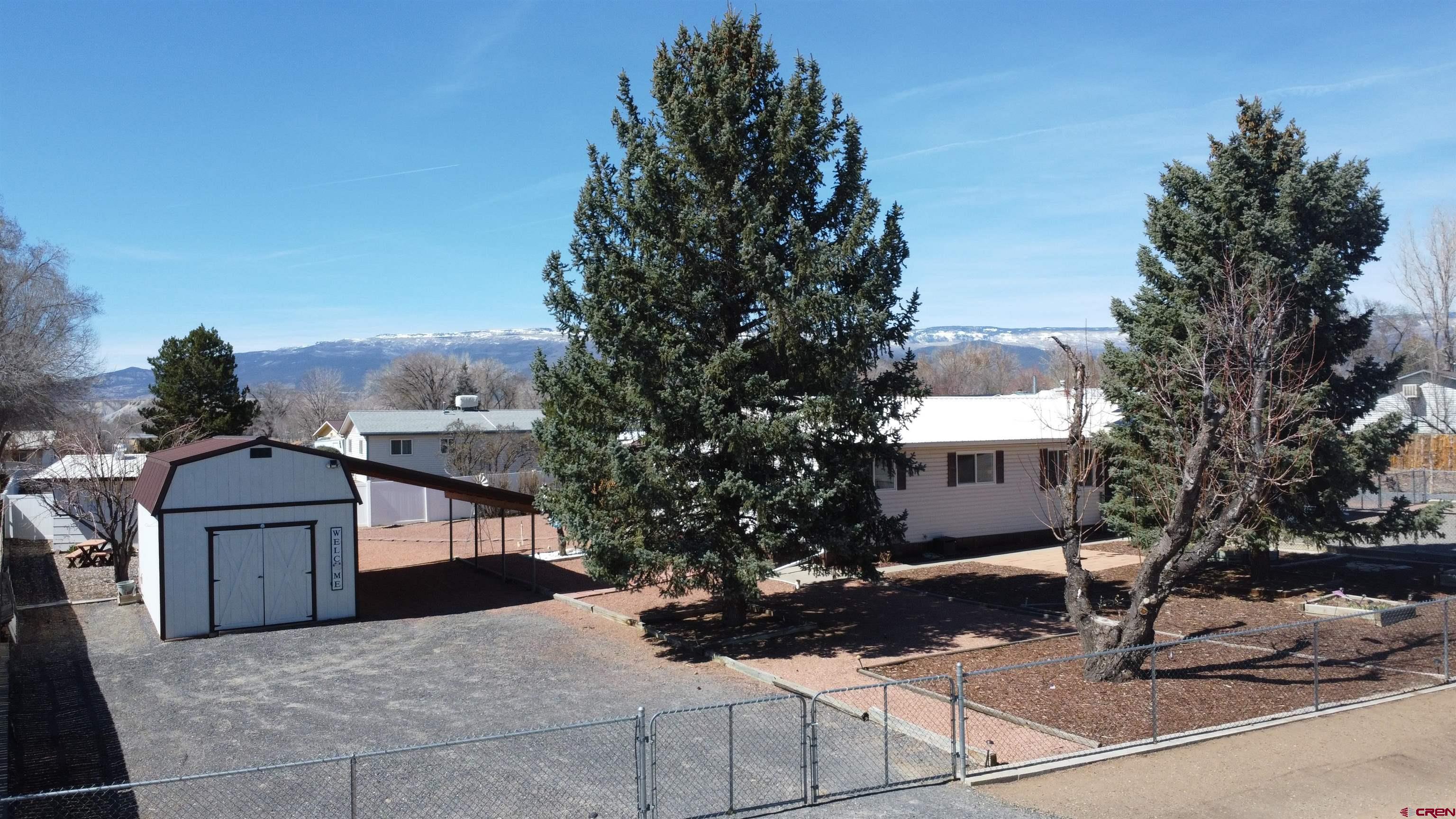 12365 East Spring Circle Eckert, CO 81418 - Photo 24 of 34 a front view of a house with garden