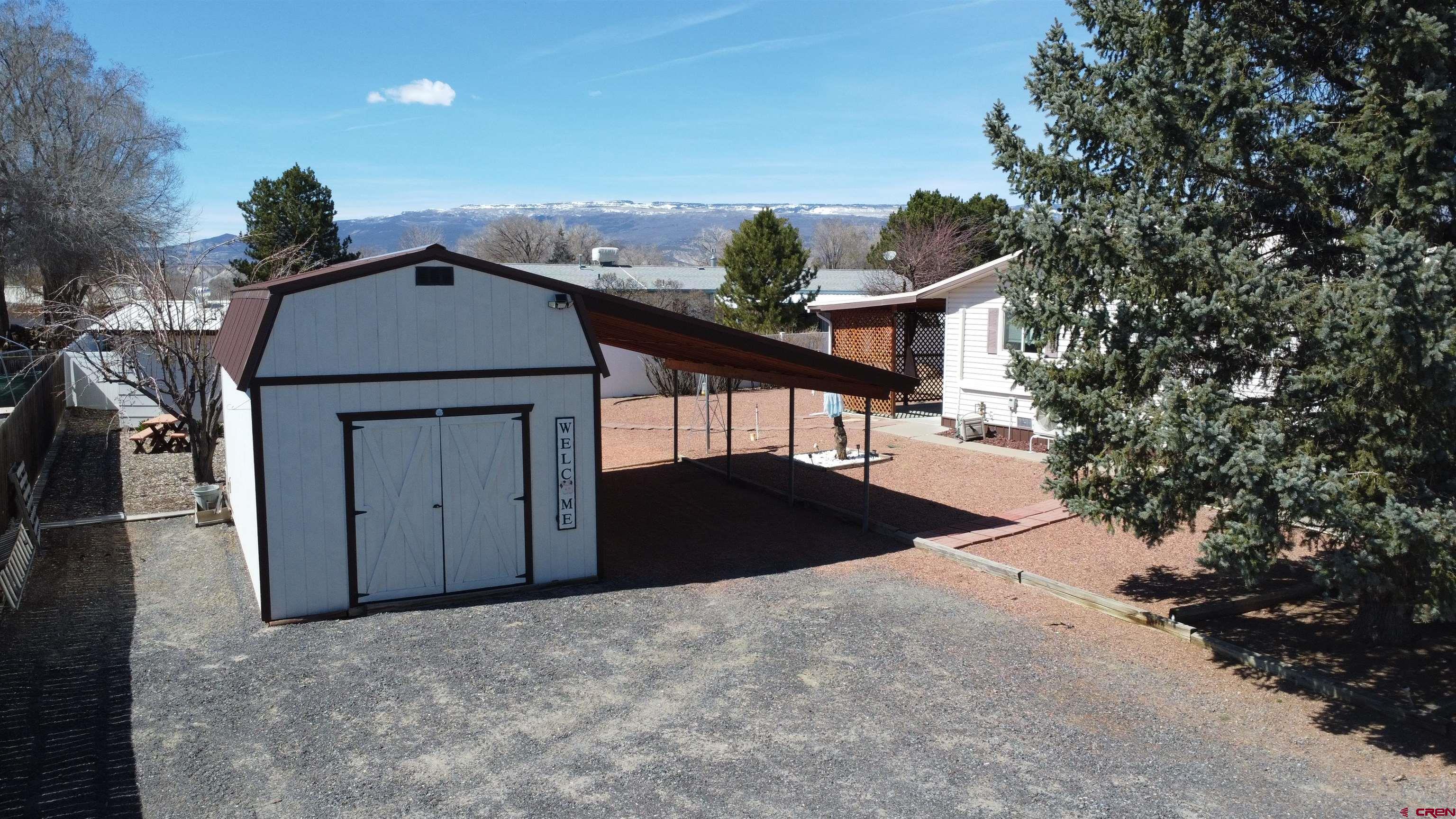 12365 East Spring Circle Eckert, CO 81418 - Photo 6 of 34 a front view of a house with a yard and garage