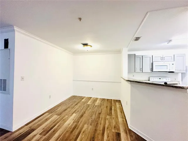 a kitchen with granite countertop a sink and a stove