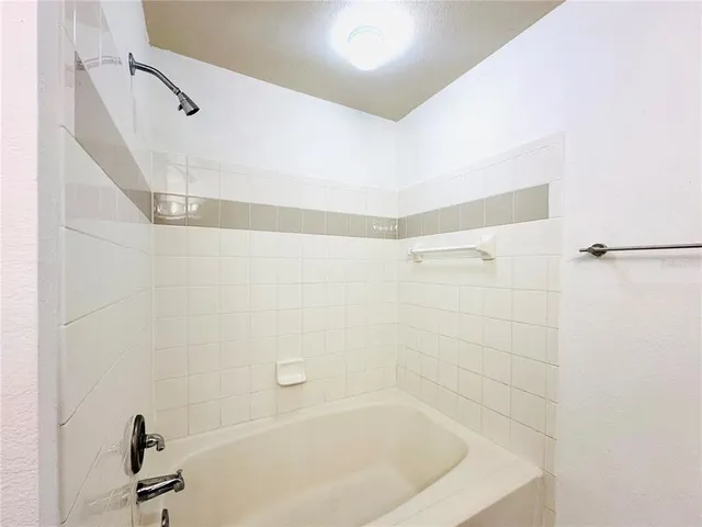a bathroom with a granite countertop sink a toilet and a mirror