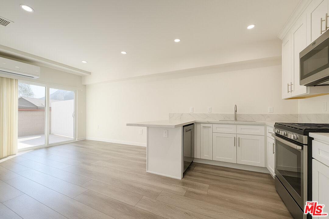 5244 Whitsett Avenue, Unit 1/4 Valley Village, CA 91607 - Photo 1 of 13 a kitchen with a sink and a stove top oven