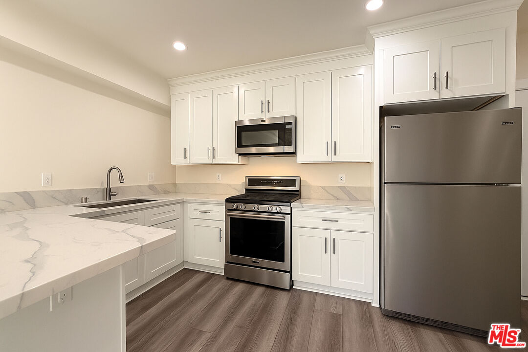 5244 Whitsett Avenue, Unit 1/4 Valley Village, CA 91607 - Photo 6 of 13 a kitchen with a sink stove and refrigerator
