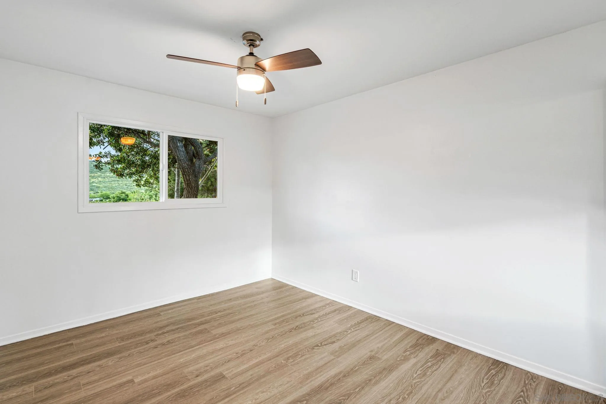10330 Strathmore Drive Santee, CA 92071 - Photo 11 of 21 wooden floor in an empty room with a window