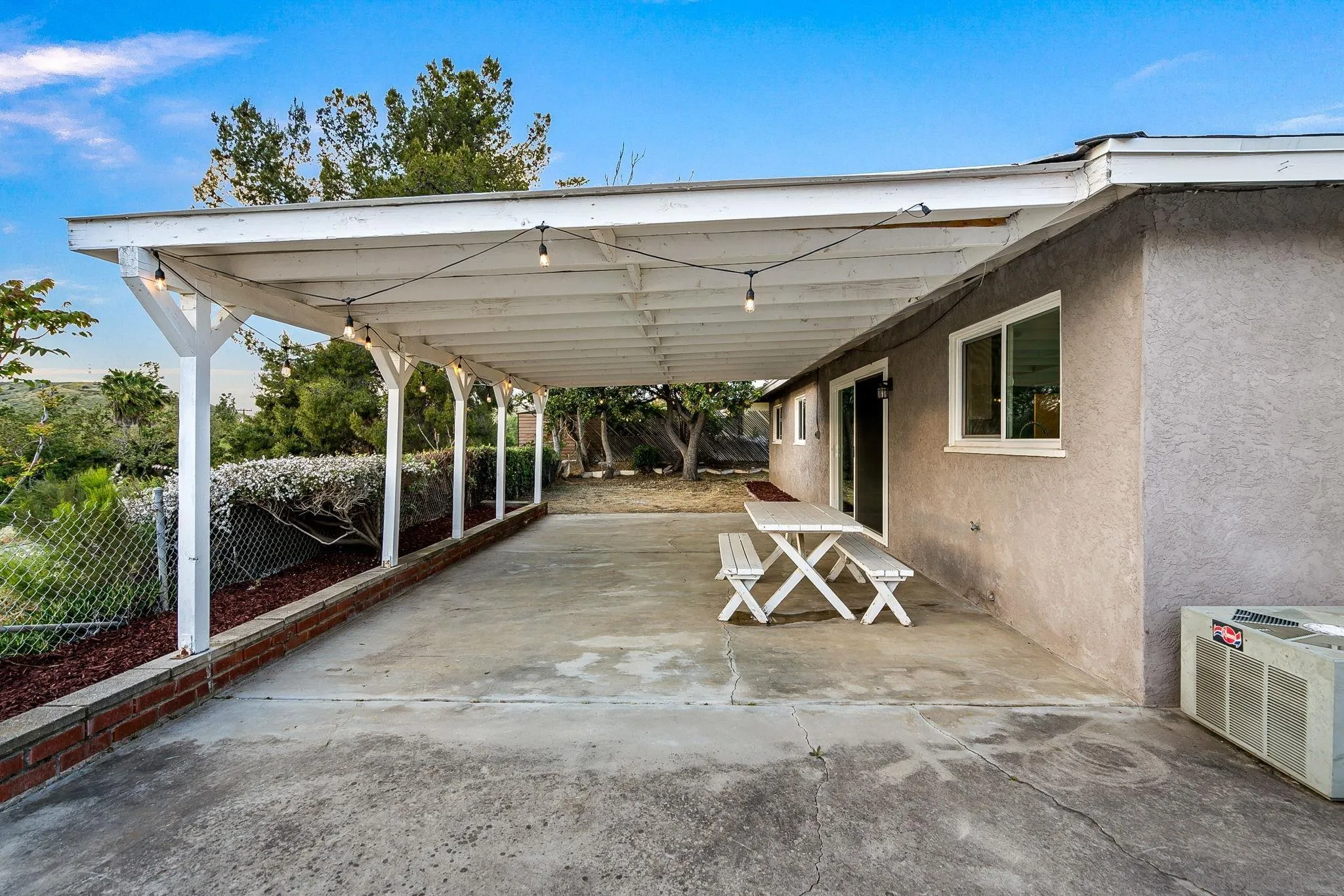 10330 Strathmore Drive Santee, CA 92071 - Photo 15 of 21 a view of a patio with table and chairs a barbeque with wooden fence