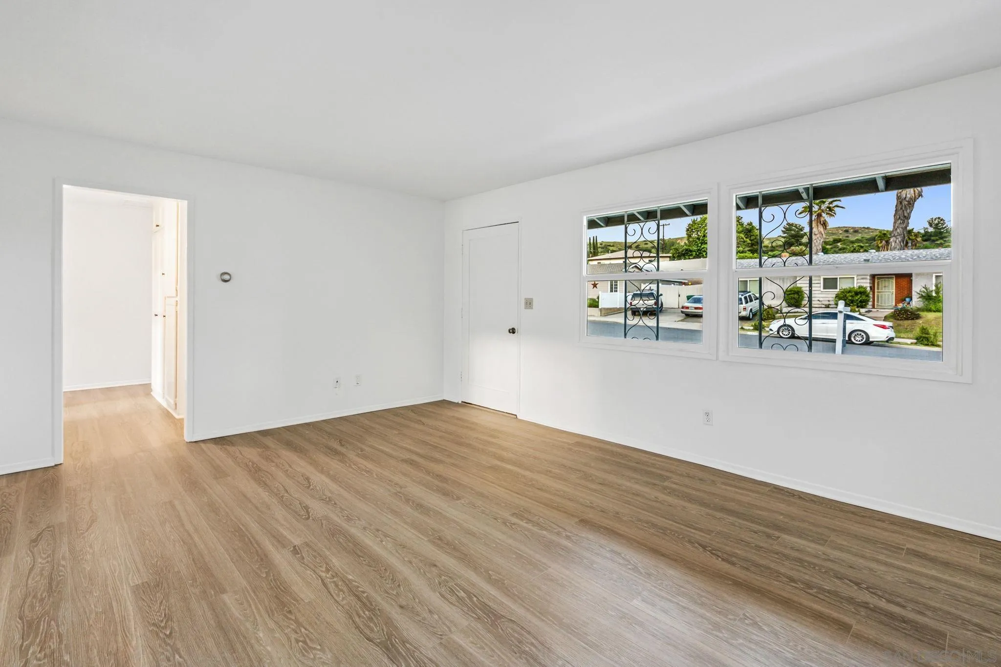 10330 Strathmore Drive Santee, CA 92071 - Photo 3 of 21 a view of empty room with wooden floor and fan