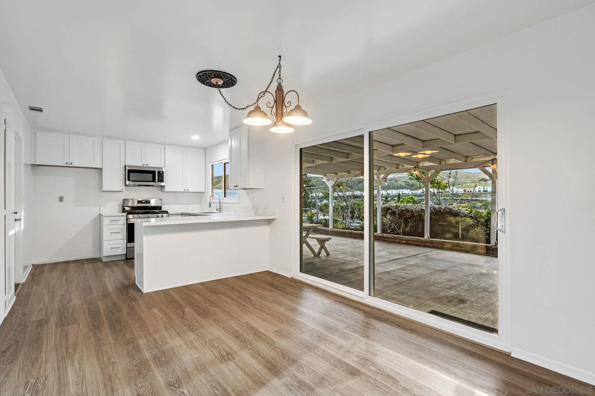 10330 Strathmore Drive Santee, CA 92071 - Photo 5 of 21 a kitchen with stainless steel appliances kitchen island wooden cabinets and white appliances