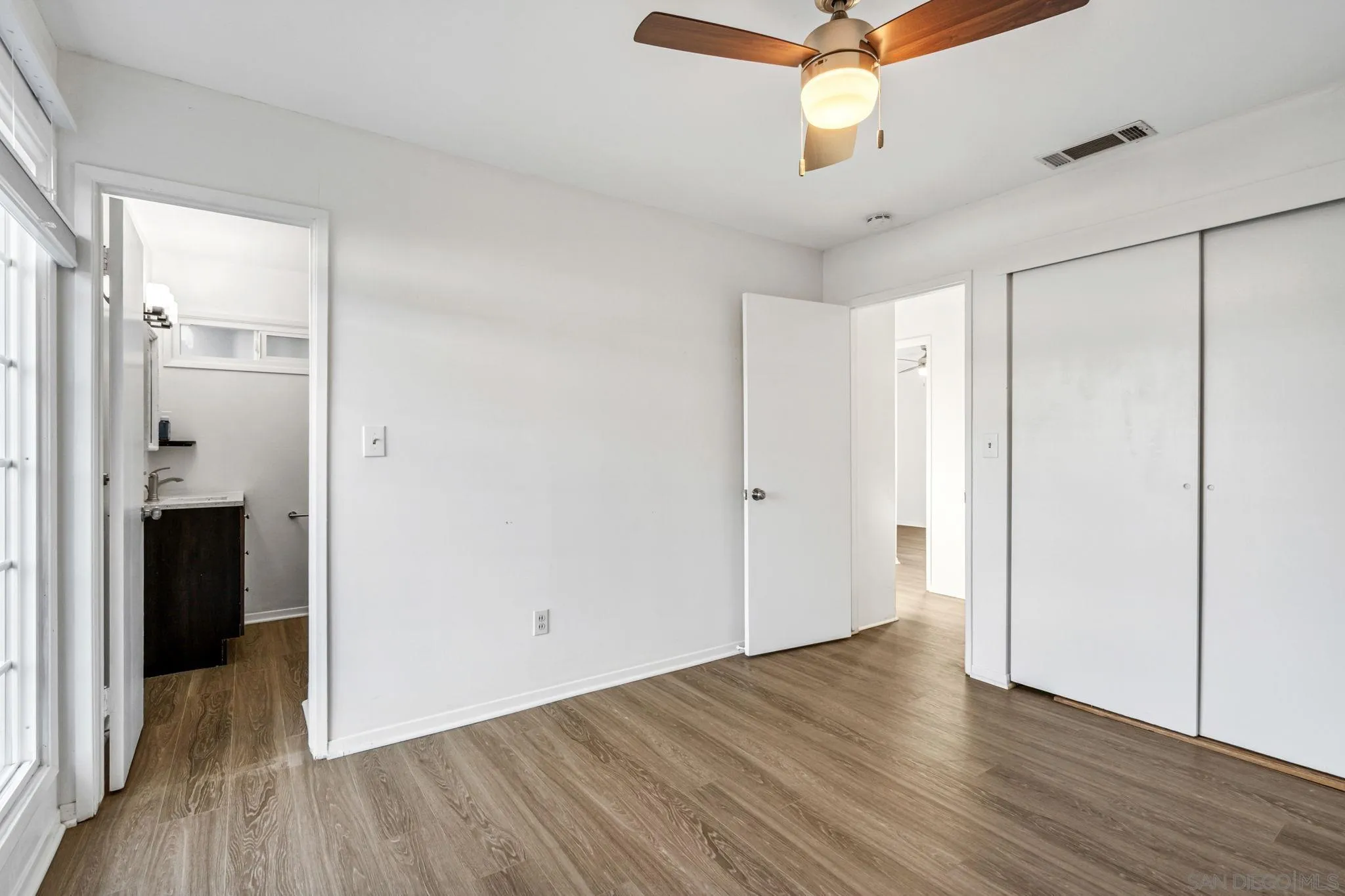 10330 Strathmore Drive Santee, CA 92071 - Photo 9 of 21 a view of a hallway with wooden floor and chandelier fan