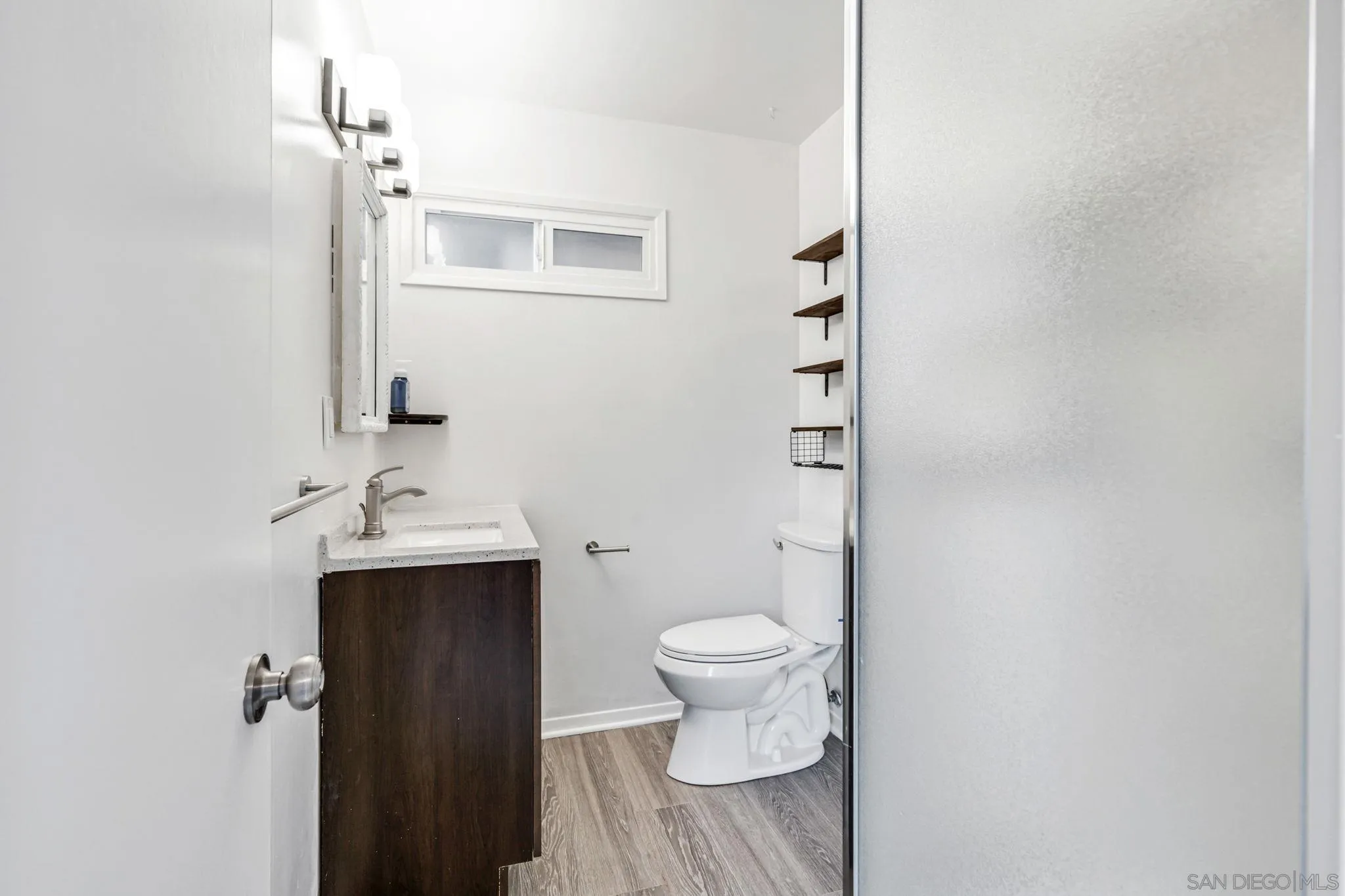 10330 Strathmore Drive Santee, CA 92071 - Photo 10 of 21 a bathroom with a sink toilet and mirror