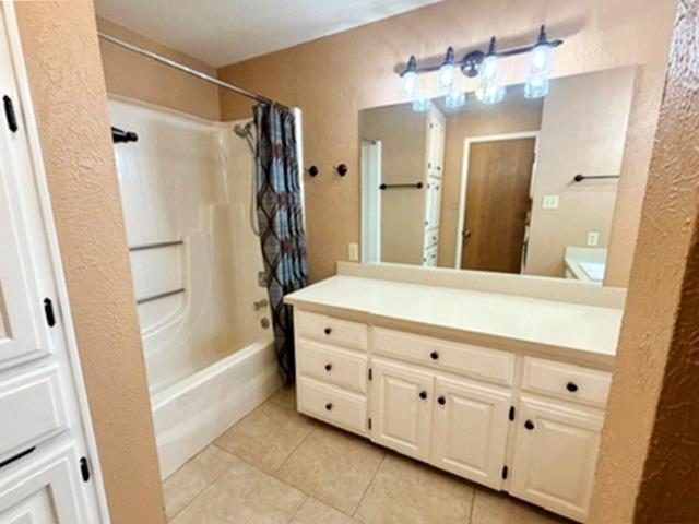 707 Rimrock Road Kerrville, TX 78028 - Photo 39 of 55 a bathroom with a double vanity sink a mirror a shower and a bathtub