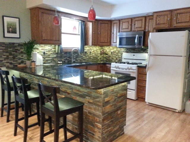 2419 Quarry Road Ashton, IL 61006 - Photo 4 of 25 a kitchen with stainless steel appliances granite countertop a stove a refrigerator a sink a dining table and chairs