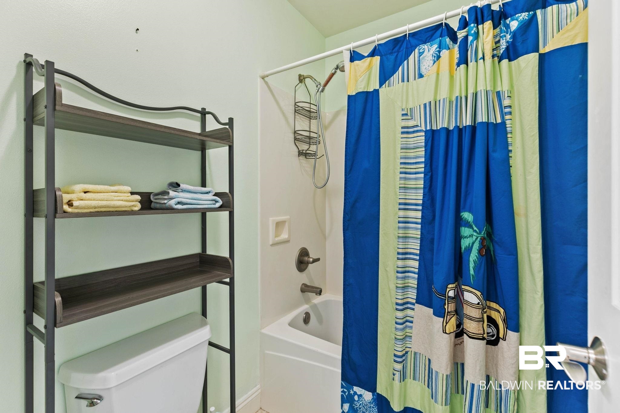 28250 Canal Road, Unit 208 Orange Beach, AL 36561 - Photo 39 of 53 Bathroom featuring shower / bath combo with shower curtain and toilet