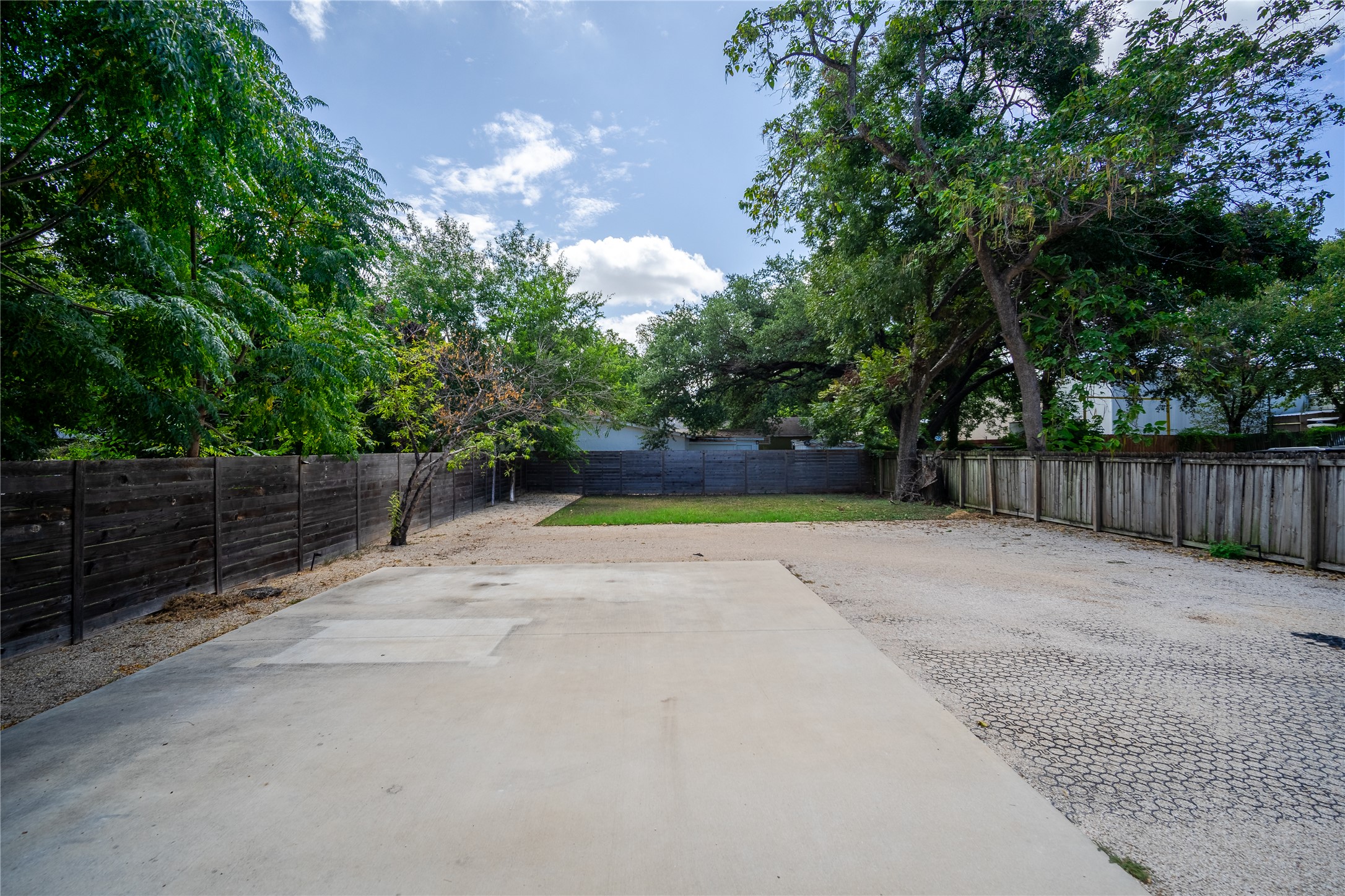719 Springdale Road Austin, TX 78702 - Photo 16 of 17 Secure yard featuring robust wood fencing and ample concrete paving for versatile outdoor use.