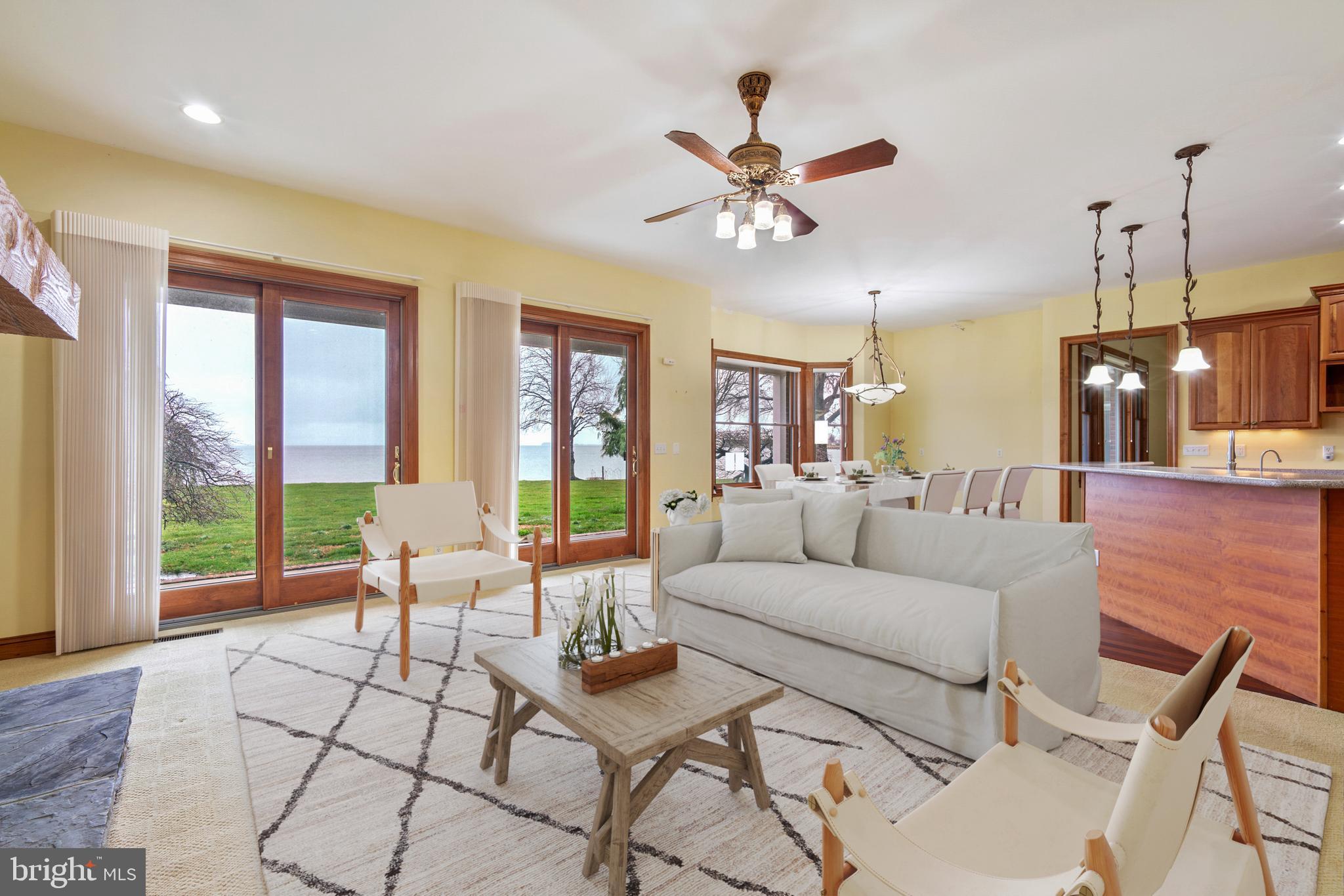 2817 Cox Neck Road Chester, MD 21619 - Photo 14 of 35 a living room with furniture and a floor to ceiling window