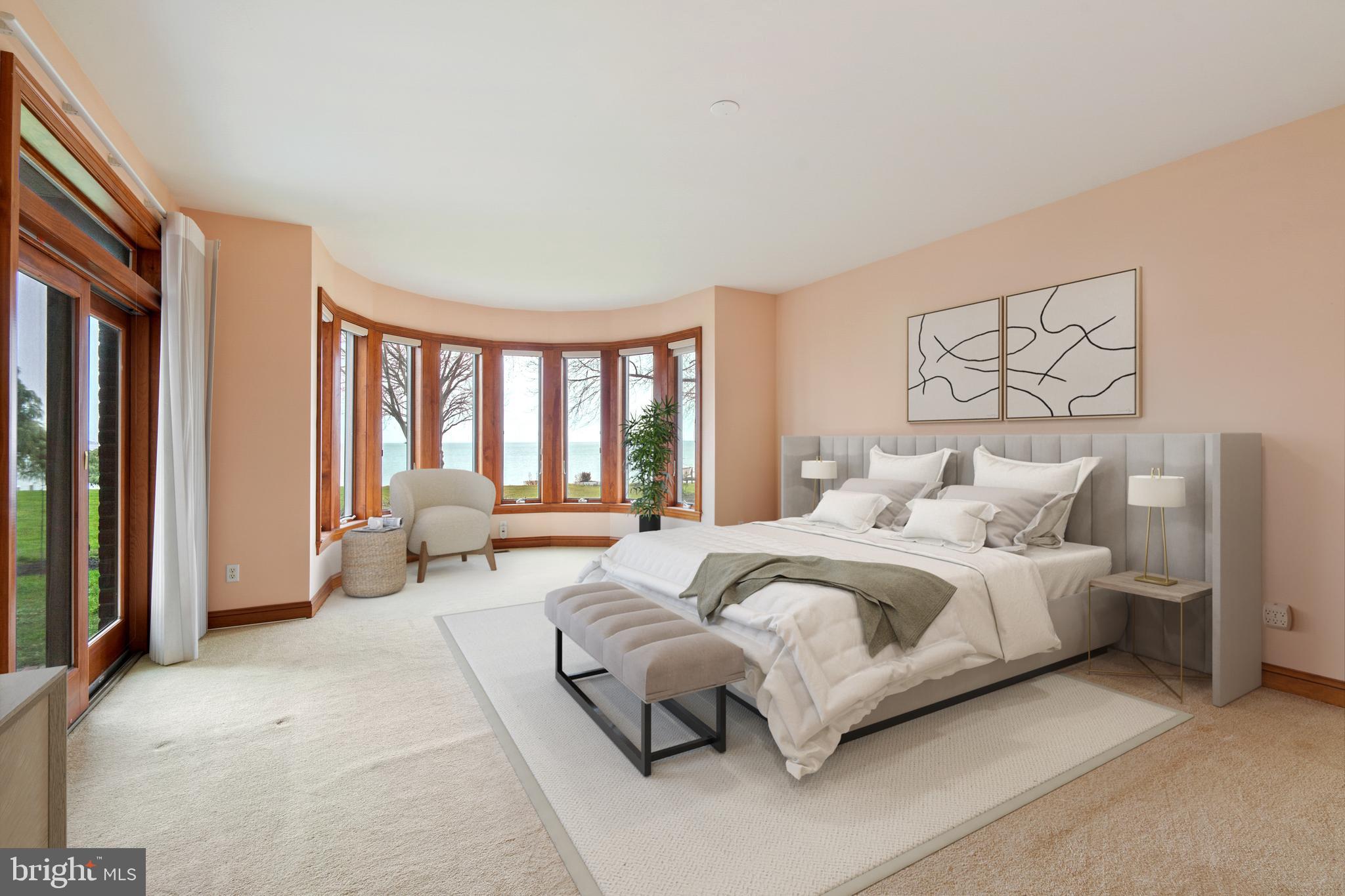 2817 Cox Neck Road Chester, MD 21619 - Photo 20 of 35 a spacious bedroom with a bed and a couch
