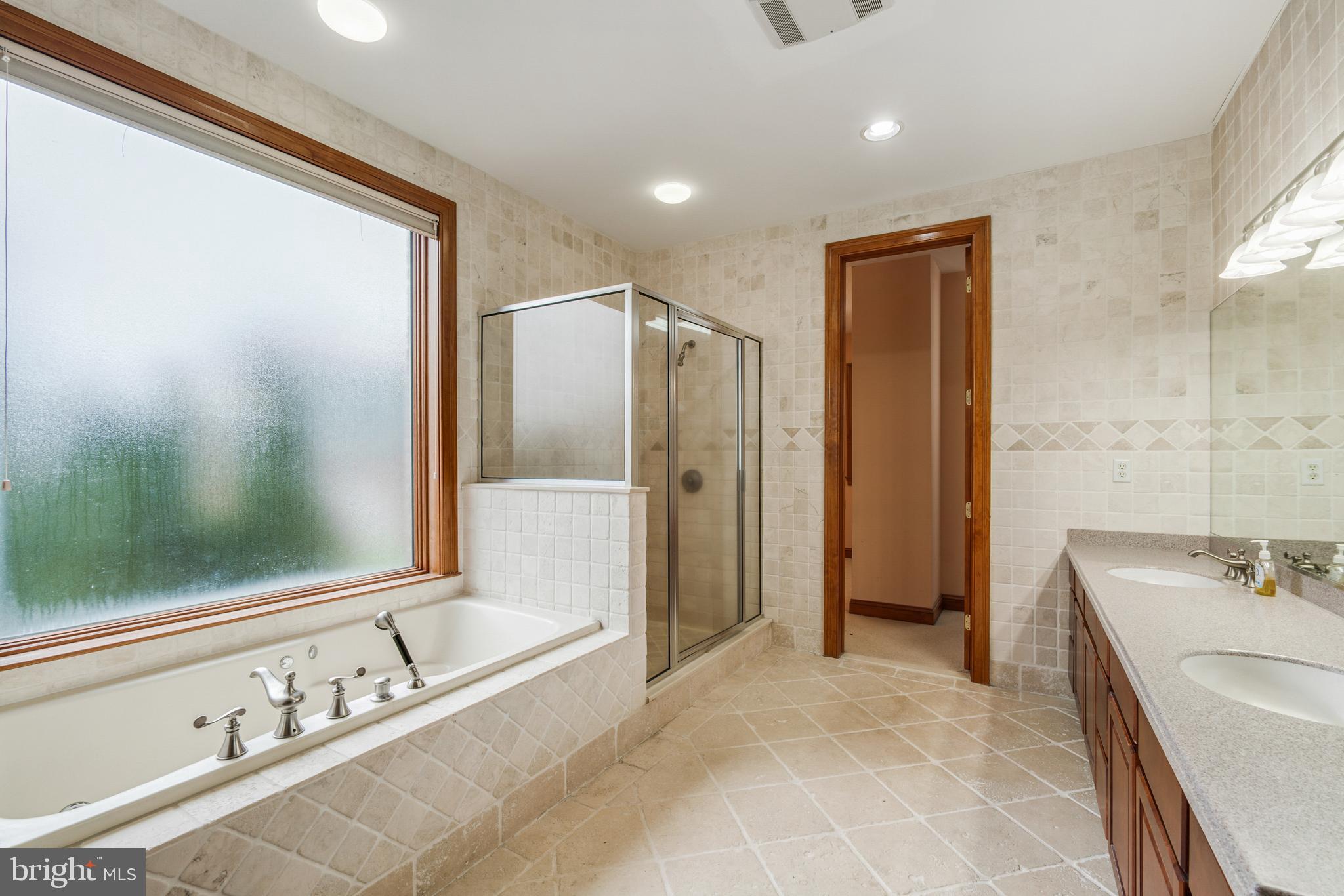 2817 Cox Neck Road Chester, MD 21619 - Photo 22 of 35 a bathroom with a tub sink and mirror