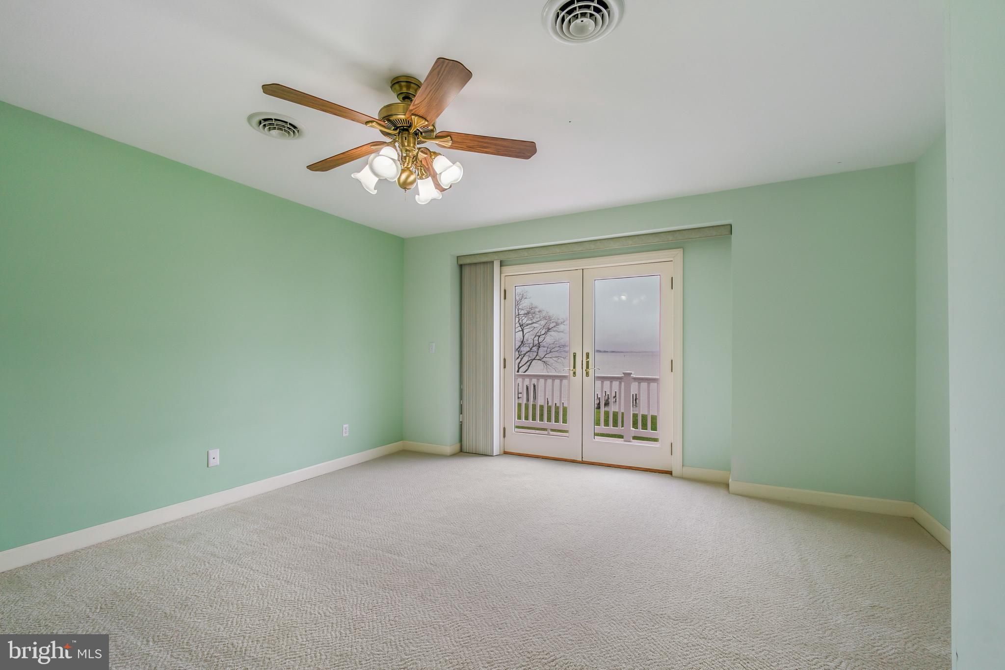 2817 Cox Neck Road Chester, MD 21619 - Photo 28 of 35 an empty room with windows and fan