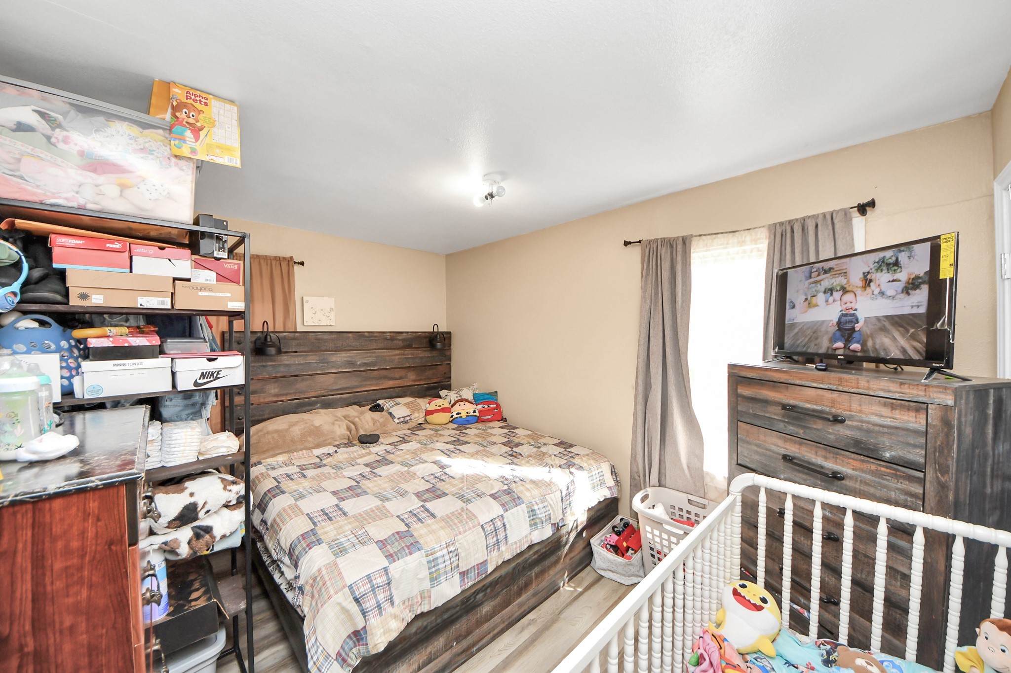 11025 Muscatine Street Houston, TX 77029 - Photo 13 of 33 a bedroom with a bed and flat screen tv
