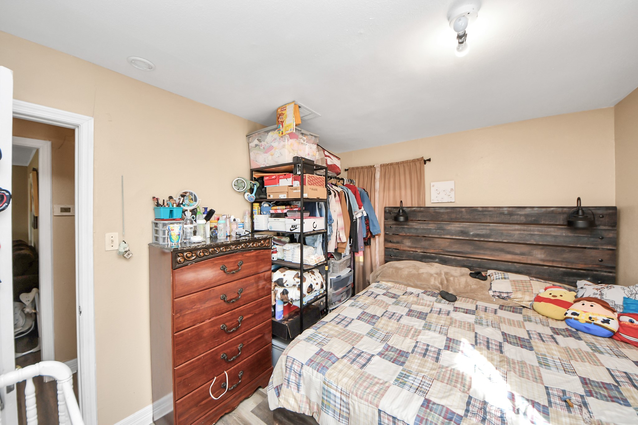 11025 Muscatine Street Houston, TX 77029 - Photo 14 of 33 a bedroom with a bed and a dresser