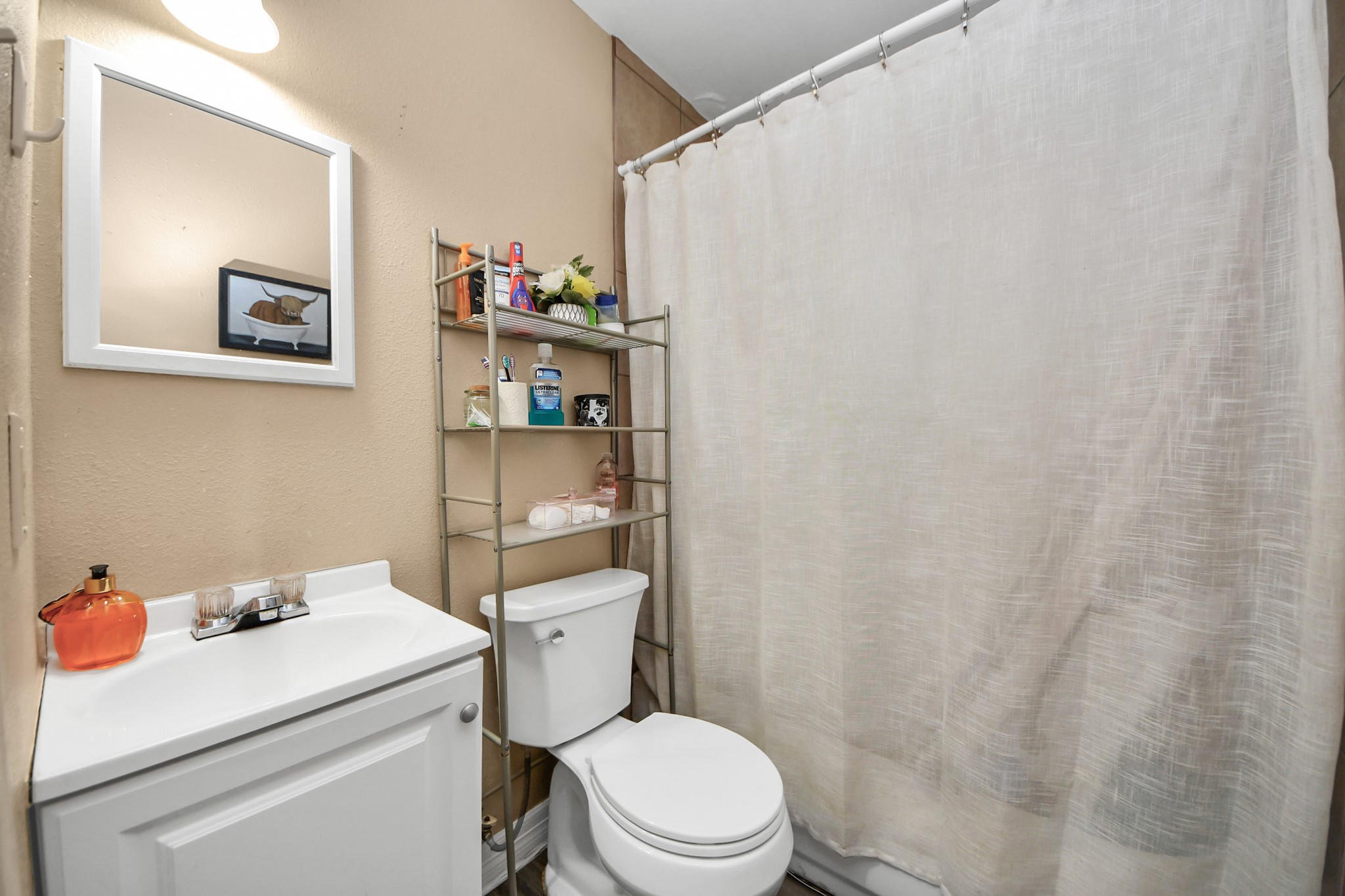 11025 Muscatine Street Houston, TX 77029 - Photo 15 of 33 a white toilet sitting next to a white sink and vanity