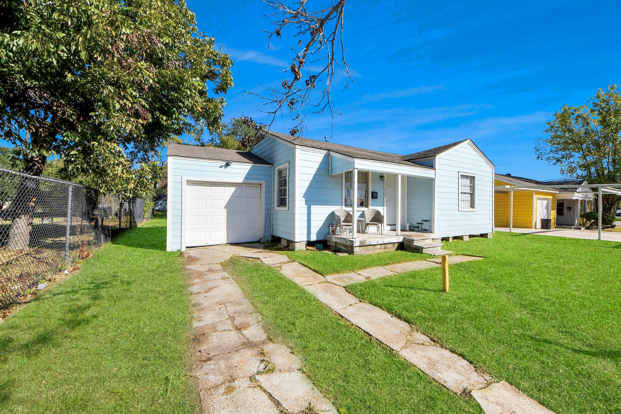 11025 Muscatine Street Houston, TX 77029 - Photo 21 of 33 a front view of a house with a yard and trees