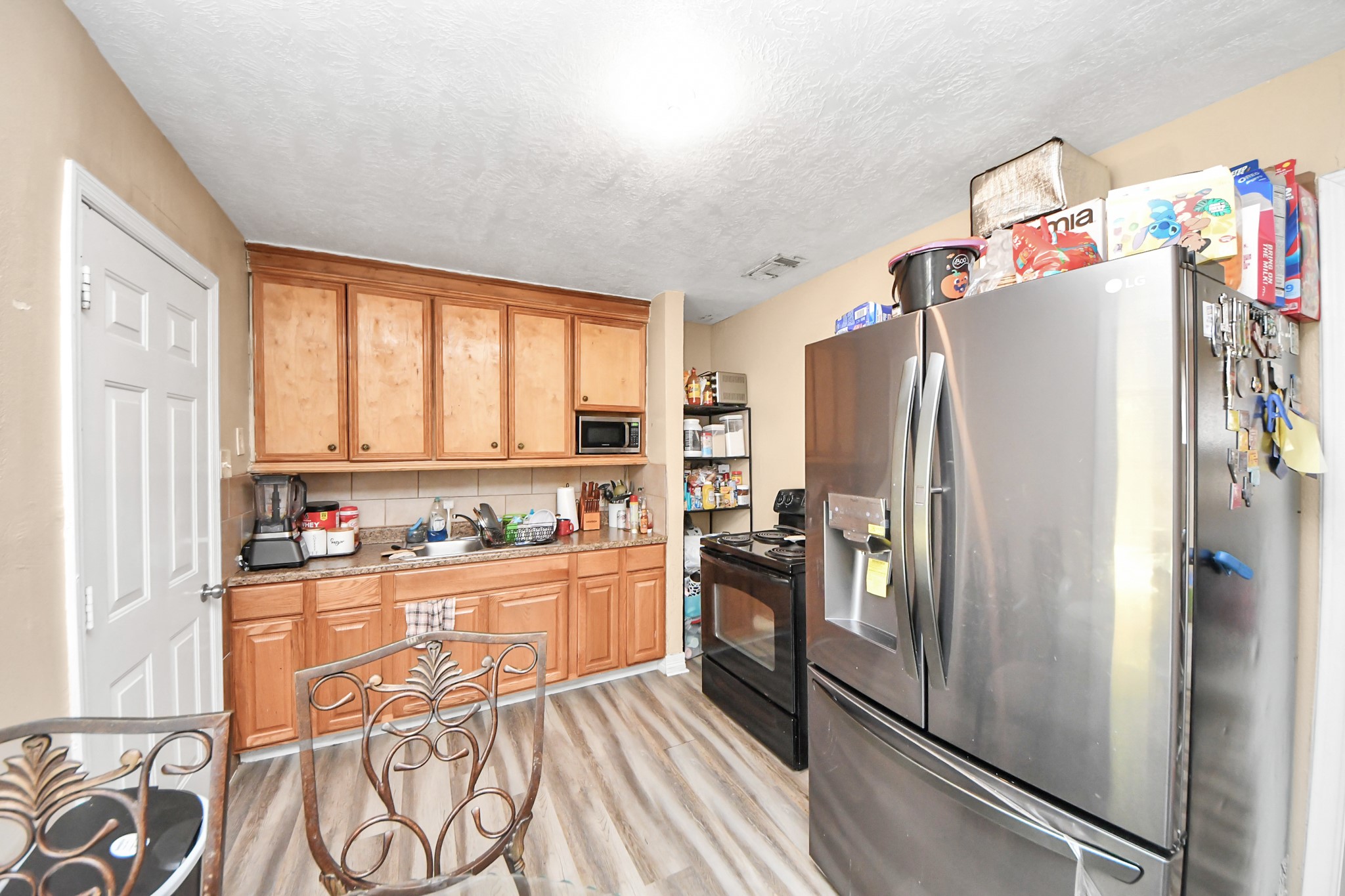 11025 Muscatine Street Houston, TX 77029 - Photo 8 of 33 a kitchen with stainless steel appliances a refrigerator and a stove top oven