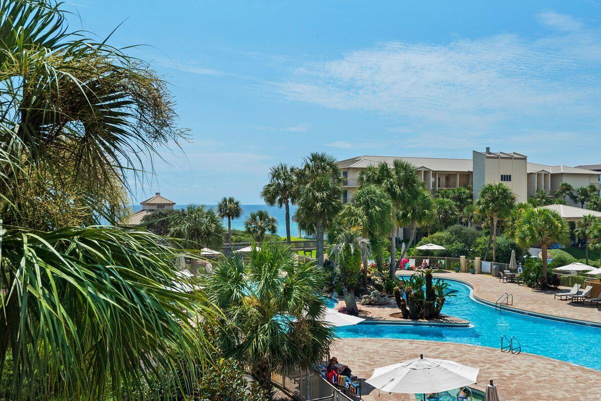 10254 East County Road, Unit 315 Inlet Beach, FL 32461 - Photo 15 of 37 a view of a swimming pool with lawn chairs plants and palm trees