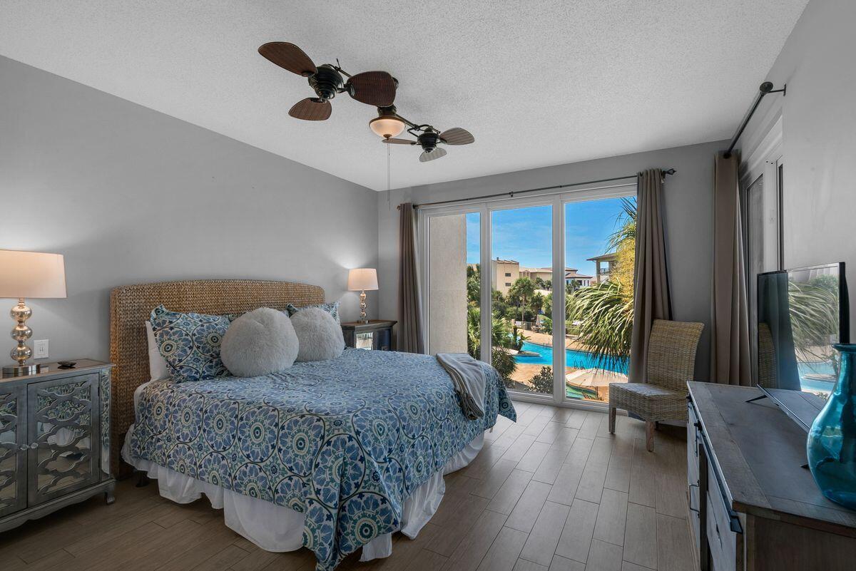 10254 East County Road, Unit 315 Inlet Beach, FL 32461 - Photo 19 of 37 a bedroom with a bed a couch and a flat tv screen on dresser
