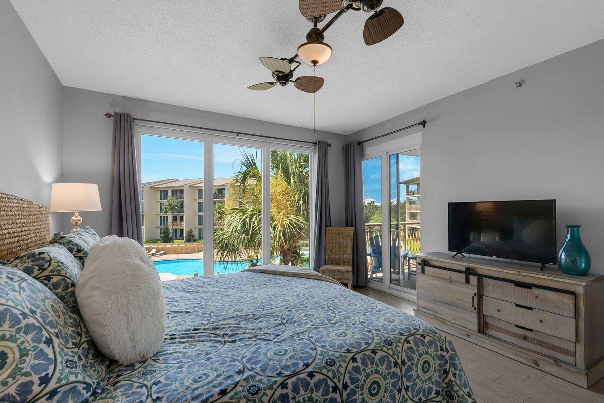 10254 East County Road, Unit 315 Inlet Beach, FL 32461 - Photo 20 of 37 a bedroom with furniture and a flat screen tv