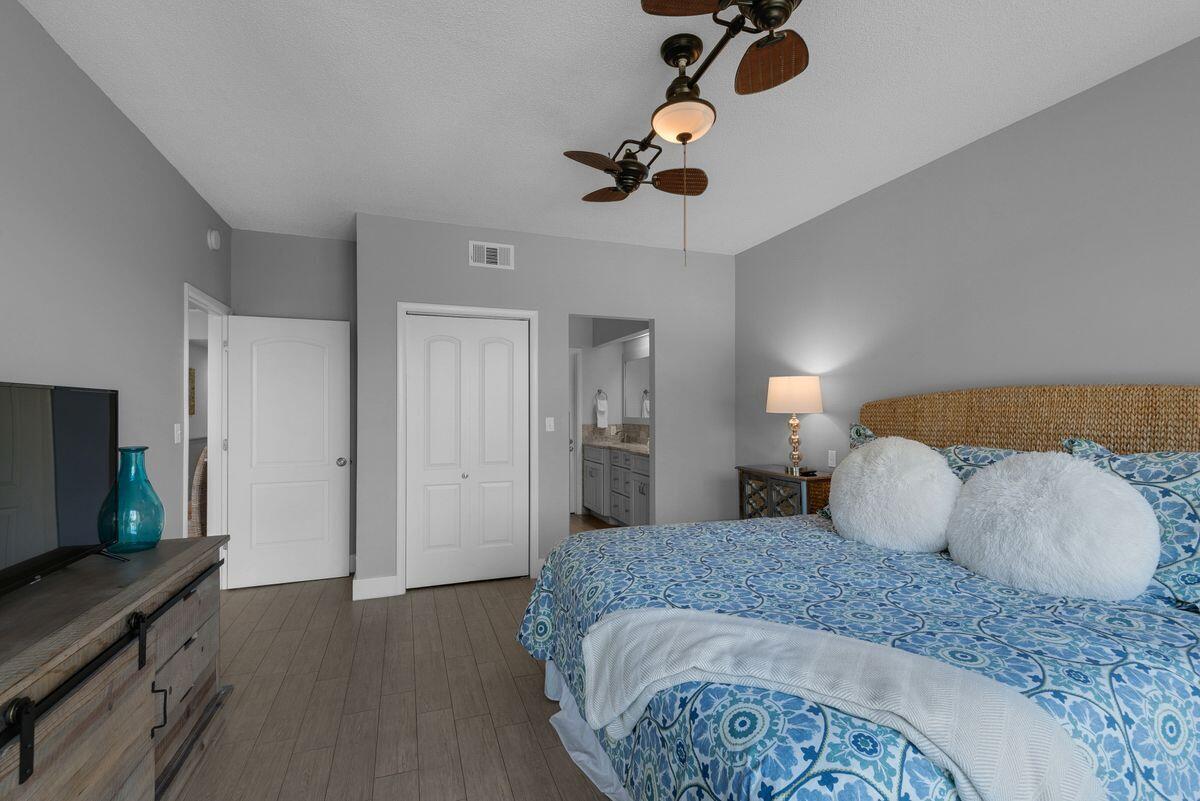 10254 East County Road, Unit 315 Inlet Beach, FL 32461 - Photo 21 of 37 a bedroom with a bed and a flat tv screen on dresser