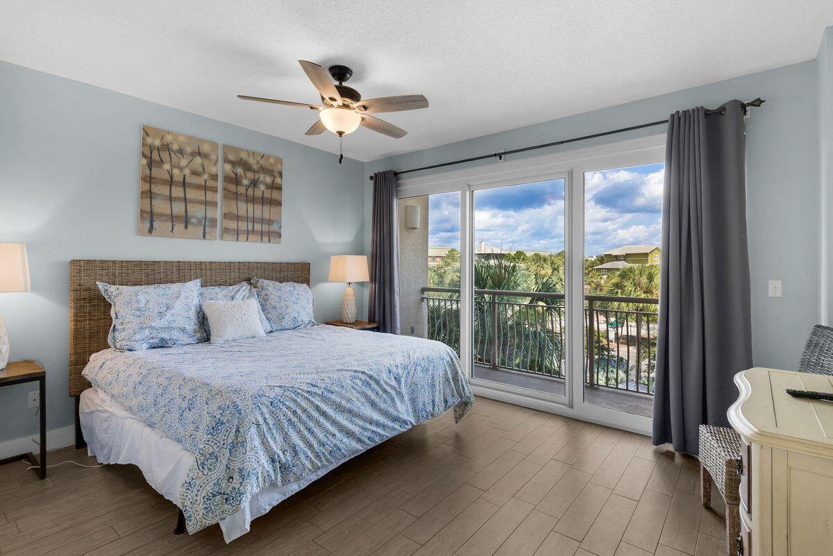 10254 East County Road, Unit 315 Inlet Beach, FL 32461 - Photo 24 of 37 a bedroom with a large bed and a chandelier
