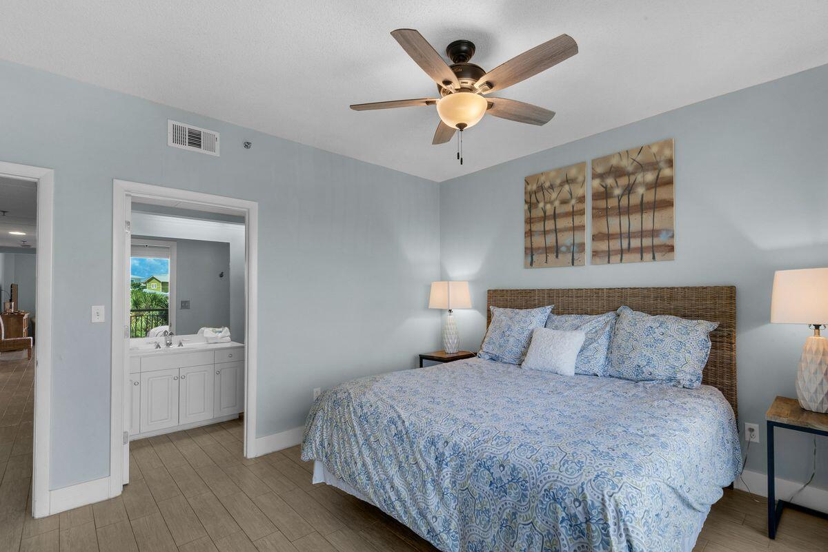 10254 East County Road, Unit 315 Inlet Beach, FL 32461 - Photo 25 of 37 a bedroom with a large bed and a chandelier