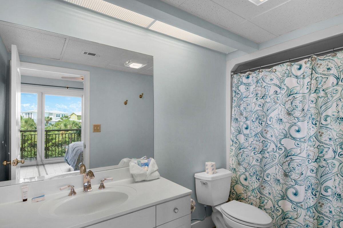 10254 East County Road, Unit 315 Inlet Beach, FL 32461 - Photo 26 of 37 a bathroom with a sink a toilet and shower curtain
