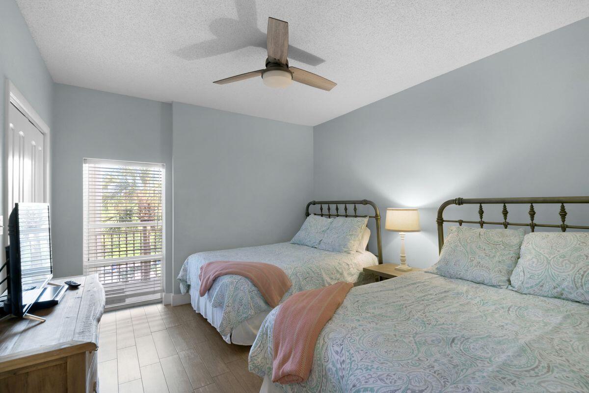 10254 East County Road, Unit 315 Inlet Beach, FL 32461 - Photo 27 of 37 a bedroom with two beds and a flat screen tv
