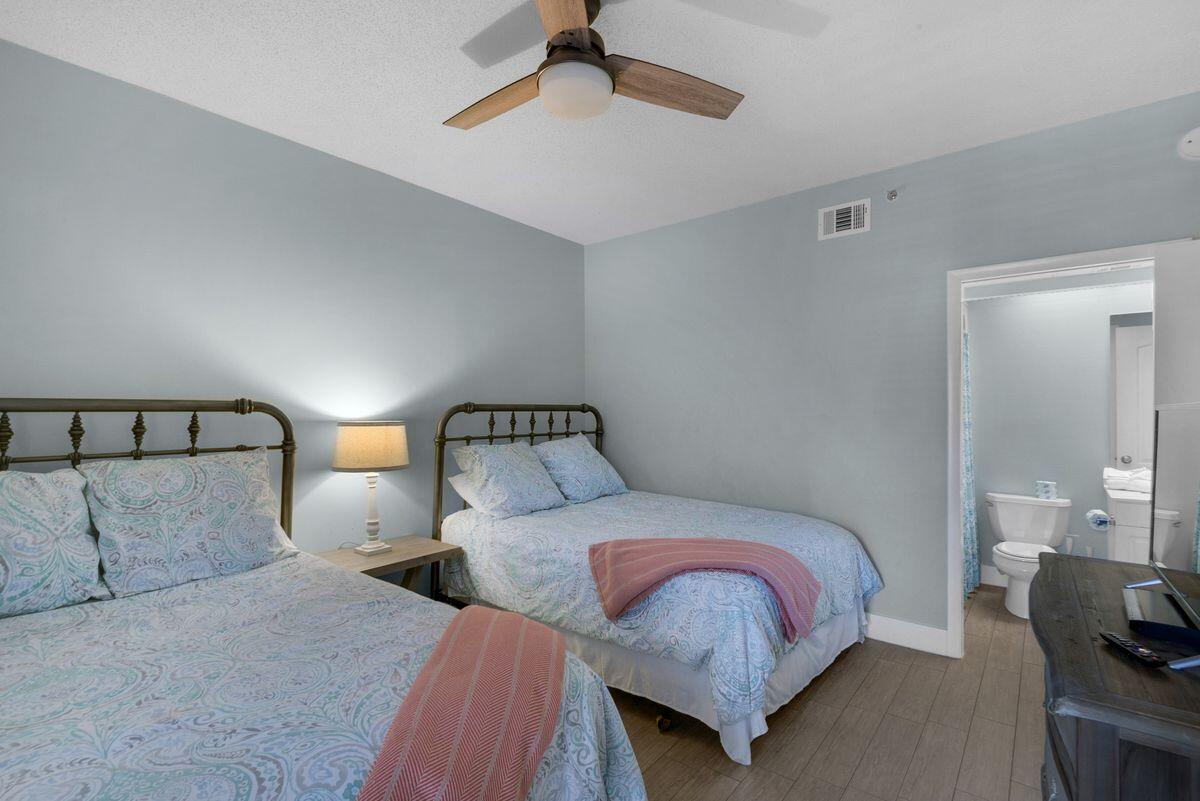 10254 East County Road, Unit 315 Inlet Beach, FL 32461 - Photo 28 of 37 a bedroom with a bed and a lamp