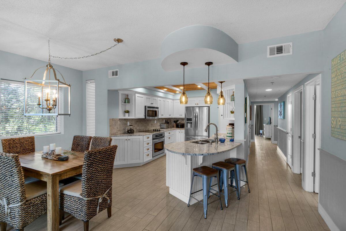 10254 East County Road, Unit 315 Inlet Beach, FL 32461 - Photo 5 of 37 a view of a dining room with furniture window and wooden floor