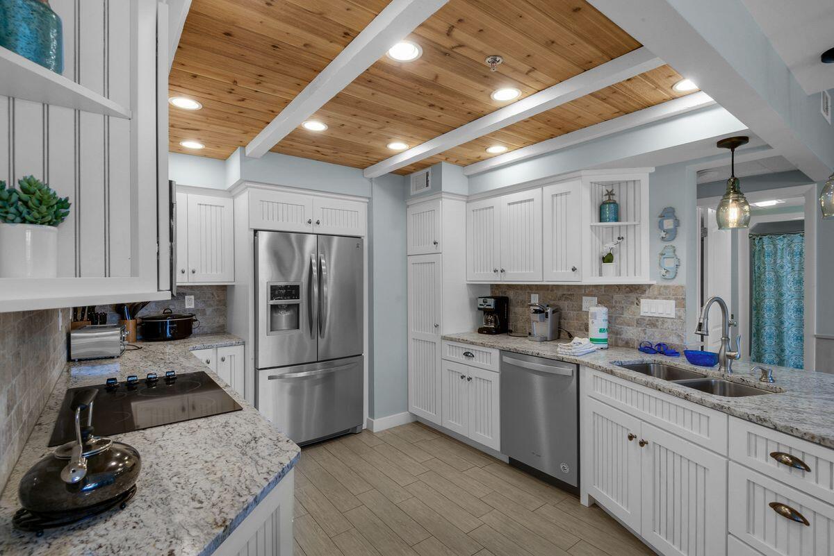 10254 East County Road, Unit 315 Inlet Beach, FL 32461 - Photo 7 of 37 a kitchen with sink refrigerator and cabinets