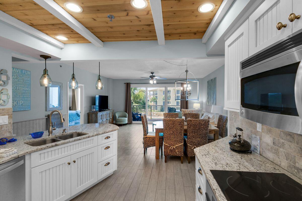 10254 East County Road, Unit 315 Inlet Beach, FL 32461 - Photo 8 of 37 a large living room with stainless steel appliances granite countertop lots of counter space furniture and a wooden floor