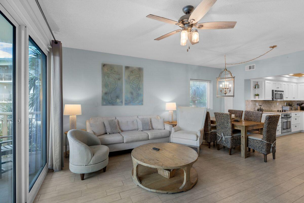 10254 East County Road, Unit 315 Inlet Beach, FL 32461 - Photo 9 of 37 a living room with furniture a chandelier fan and a window