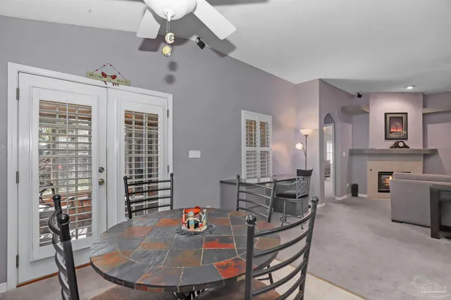 a living room with furniture a dining table and a chandelier