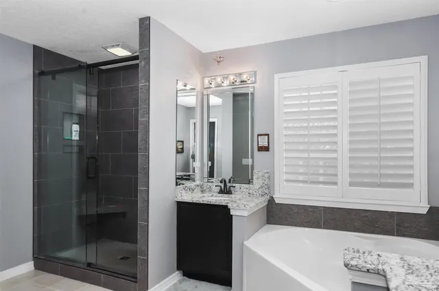 a bathroom with a bathtub and a sink