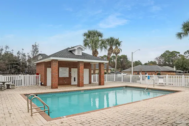 swimming pool view with a seating space